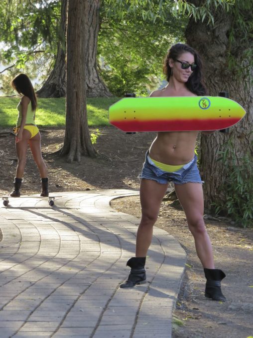 Sexy Brunette with Shorts Unbuttoned Holding Skateboard