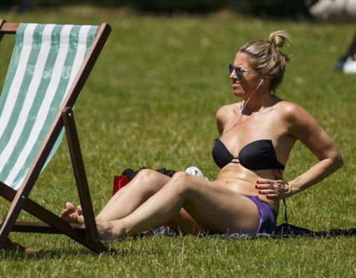 Woman Sun Tanning in Park