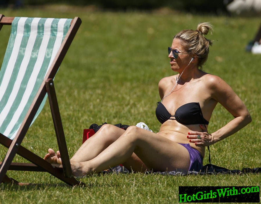 Woman Sun Tanning in Park